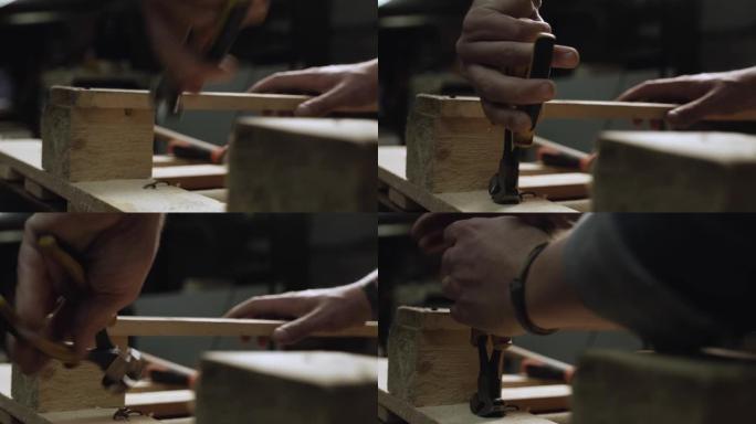 铁钳咬掉木板上的钉子。用铁切割钳工作。拆卸一个木制托盘。