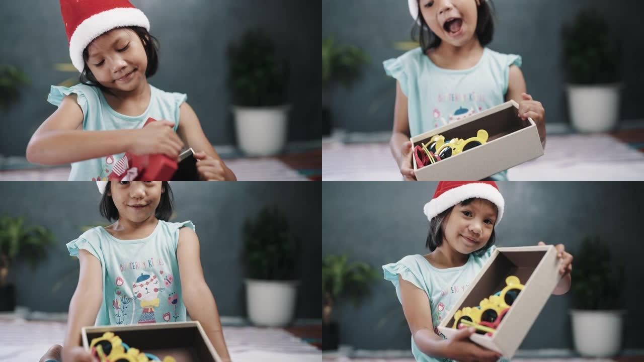 戴圣塔帽子的女孩打开礼品盒。