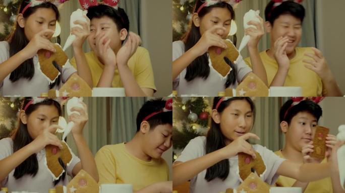 亚洲儿童在晚上在家一起制作姜饼屋，圣诞节庆祝生活方式。