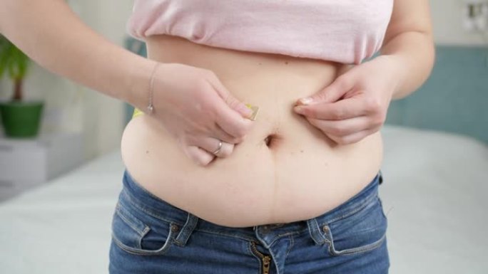 年轻女子体重过重，测量她的大肚子。节食的概念，不健康的生活方式，超重和肥胖