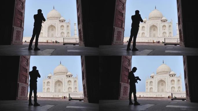 一位年轻的男摄影师拍摄美丽的泰姬陵的剪影