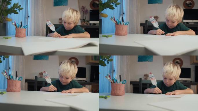 晚上在家中用笔和羽毛笔在白纸上绘画儿童