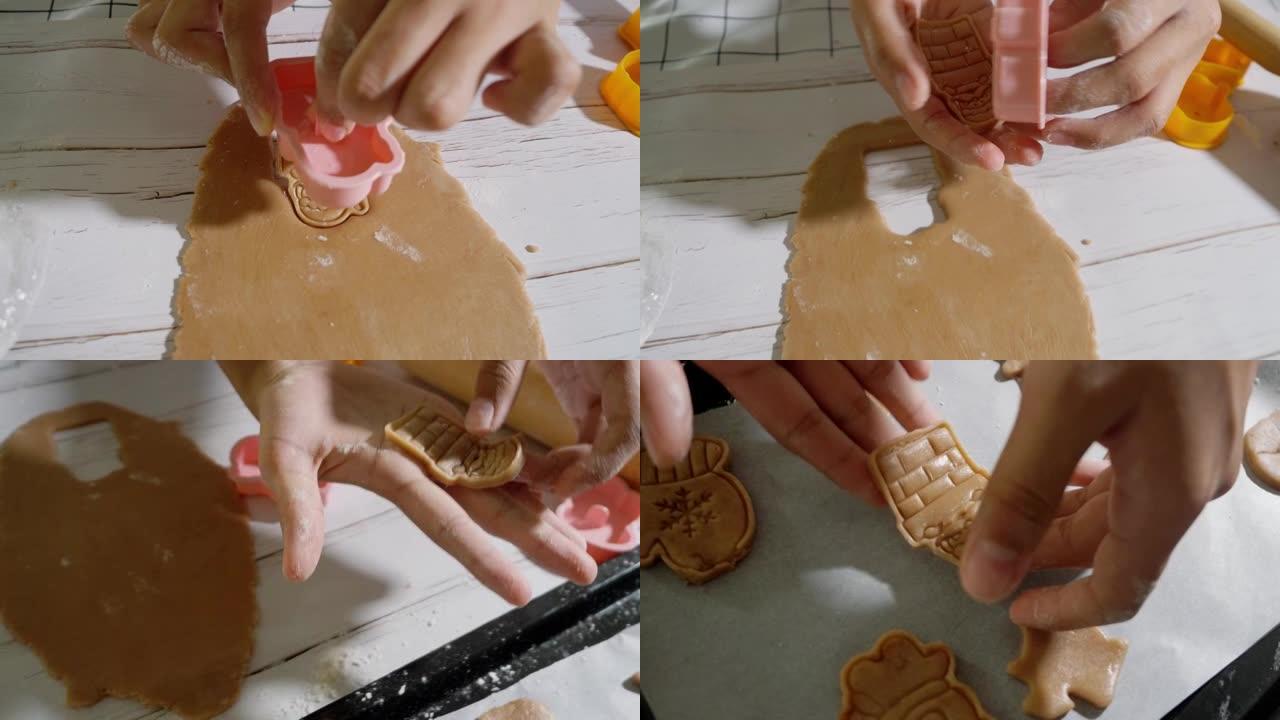 儿童的手使用饼干切割器成型自制饼干，庆祝圣诞节，生活方式的概念。