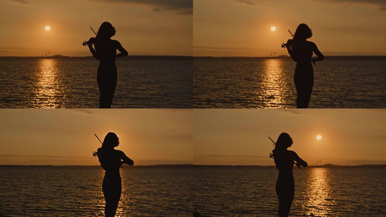 日出时女小提琴手的剪影