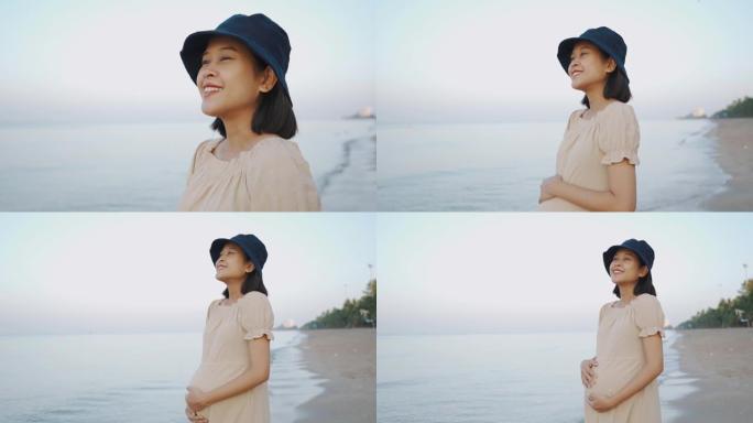 亚洲孕妇在沙滩上散步