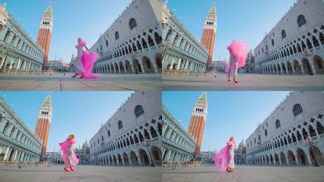 模特穿着高跟鞋和粉红色连衣裙在威尼斯快乐地行走