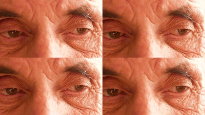 老年人眼科主题。视力不佳的养老金领取者的眼睛特写。一个白人男人的疲惫表情极端特写。眼球视力检查。选择