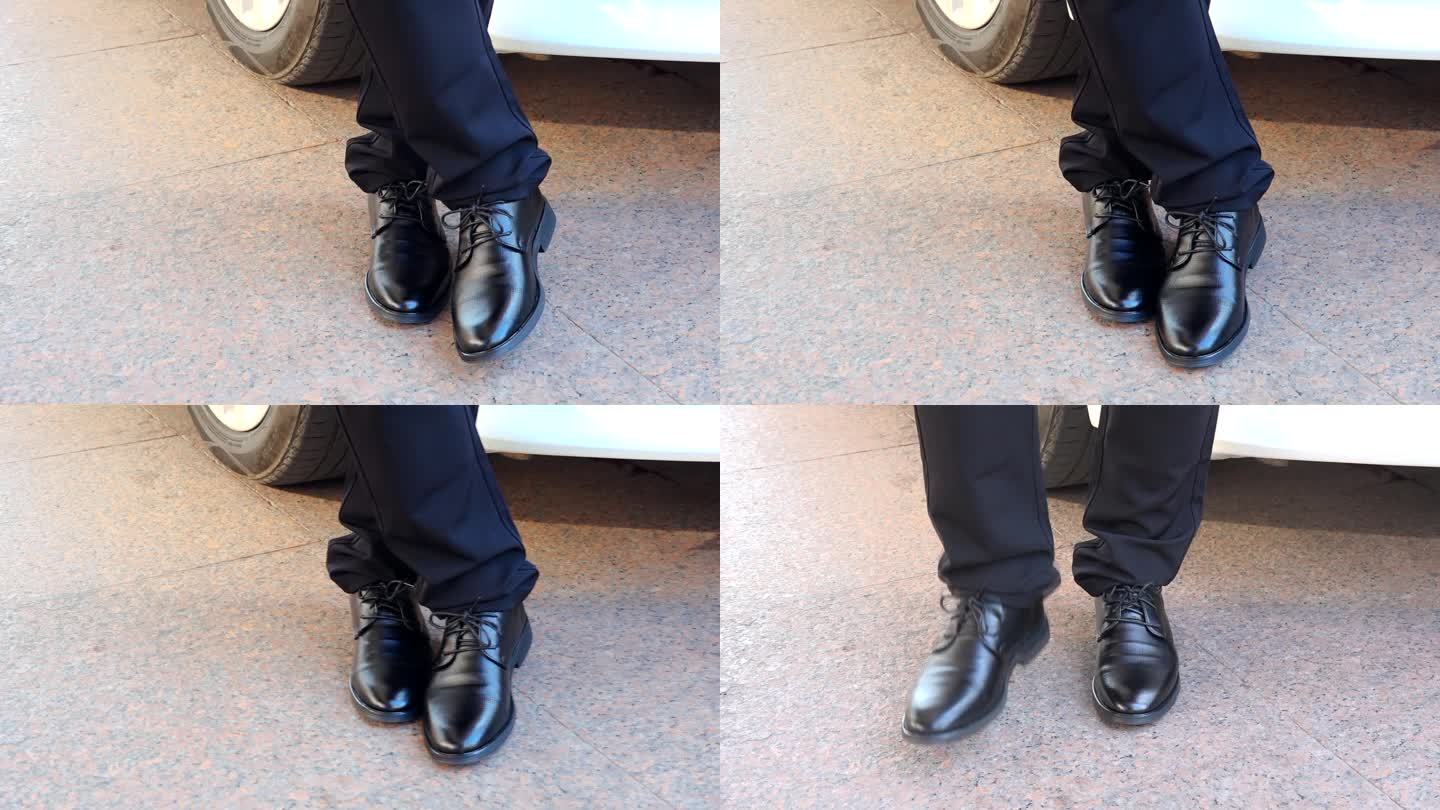 男人脚上的黑色皮鞋