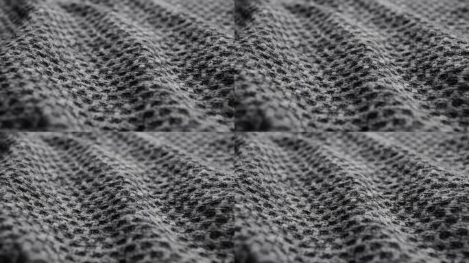 粗糙的灰色波浪形织物质地。皱纹纹理灰色材料