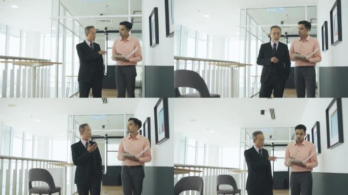 亚洲华人首席执行官走在办公室的走廊上，命令他的男秘书
