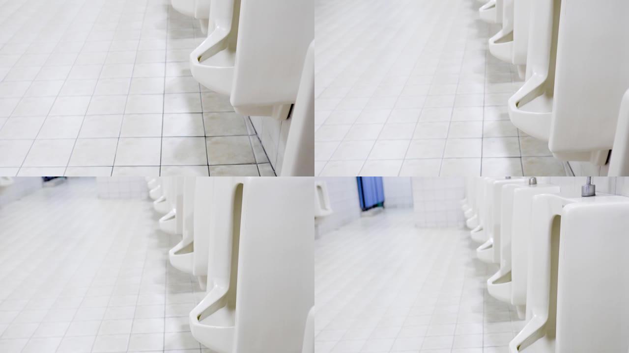 现代建筑中的男厕所。从下到上倾斜镜头。主题在右边。厕所的外观非常干净。