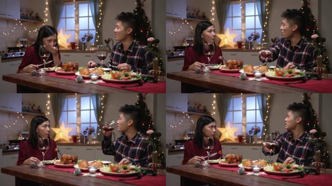快乐的亚洲已婚夫妇在节日餐桌上一起吃喝，在家里庆祝圣诞节和新年，气氛舒适