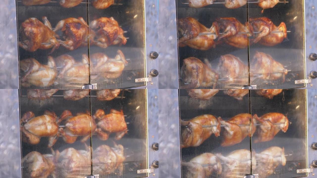烤鸡在户外封闭的烤箱中在烧烤架上旋转