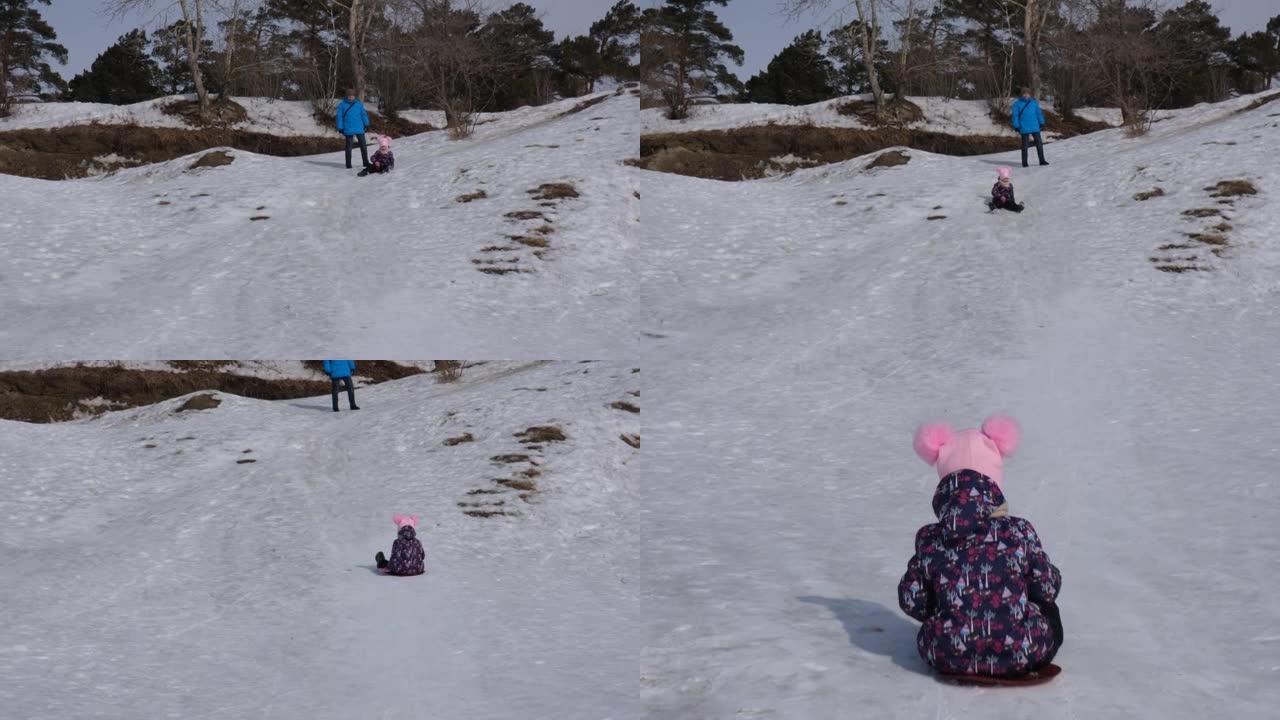 低段拍摄的儿童滑下山坡并撞向相机