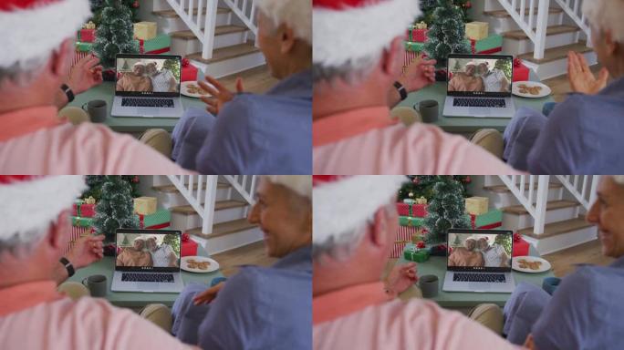 快乐的高加索高级夫妇在圣诞节与朋友进行视频通话