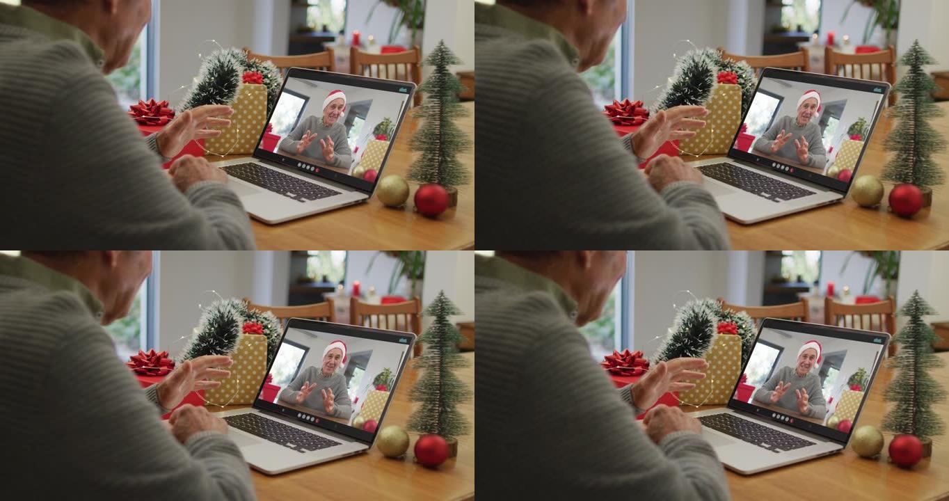 白人高级男子在笔记本电脑上与白人高级男性朋友进行圣诞节视频通话