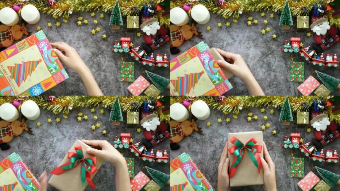 4K.手从带有圣诞节装饰品装饰的桌子上的购物袋中拿出圣诞节礼物的礼品盒。季节问候期间的在线购物和营销