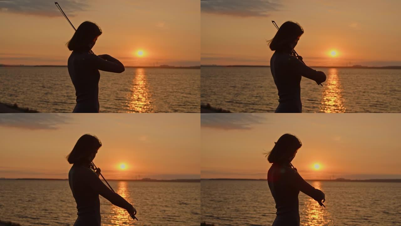 女小提琴手在金色的阳光下演奏