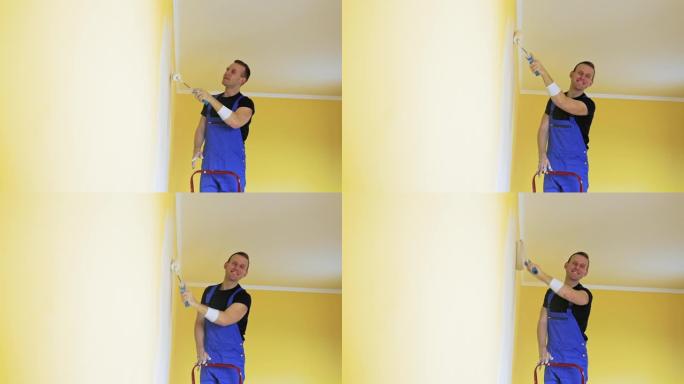穿着工作服的人在墙上粉刷。穿着制服的工人用油漆滚筒粉刷墙壁