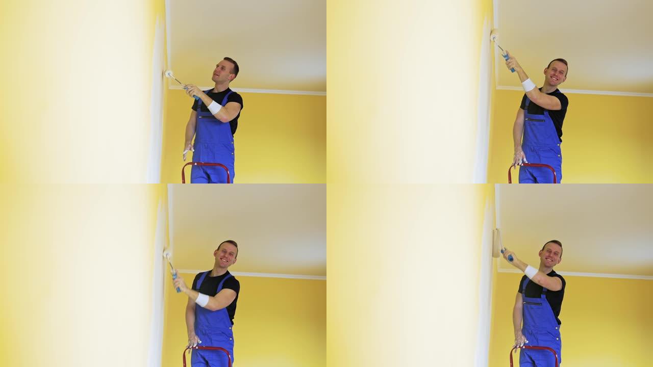 穿着工作服的人在墙上粉刷。穿着制服的工人用油漆滚筒粉刷墙壁