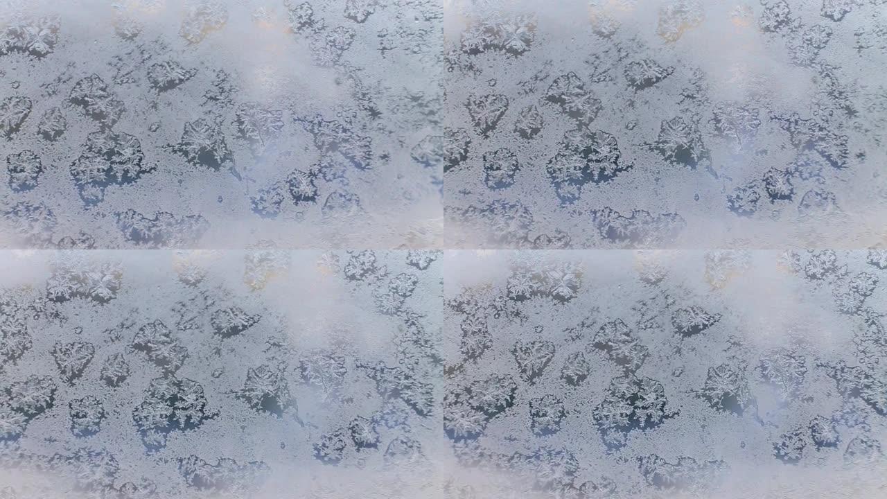 冰霜玻璃上的雪图案。窗户上的雪花图案