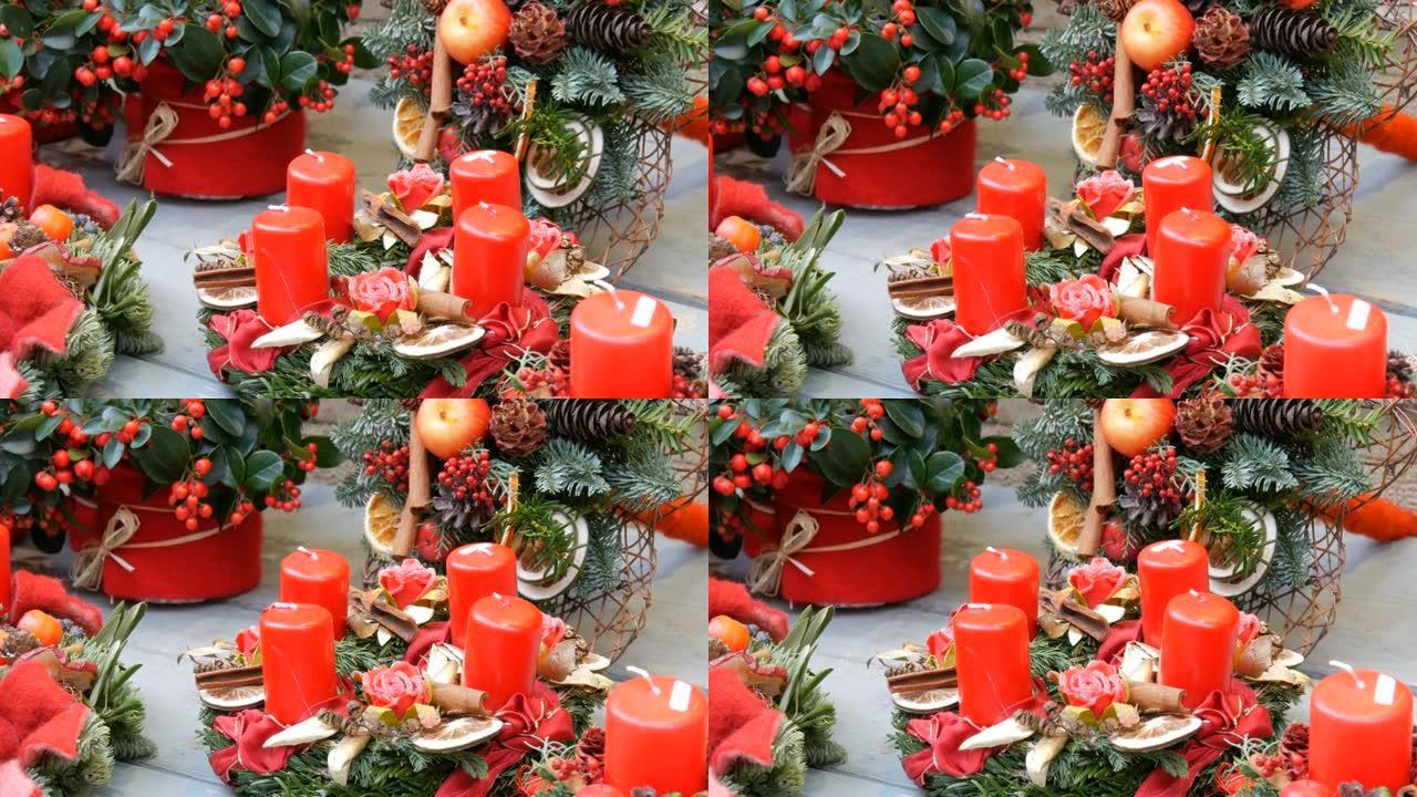 商店橱窗上装饰精美的红蜡蜡烛和花环的圣诞装饰组合物