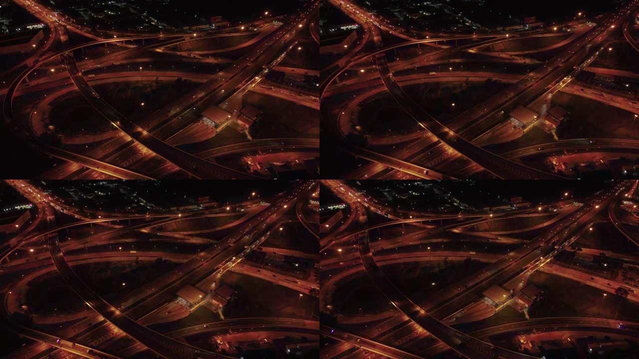 无人驾驶飞机在夜景城市正上方与高架道路桥梁交叉路口