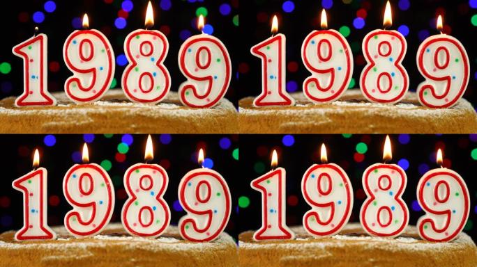 生日蛋糕与白色燃烧的蜡烛在数字1989的形式