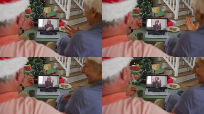 快乐的高加索高级夫妇在圣诞节与女性朋友进行视频通话