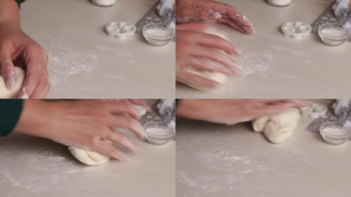 一个女人用糖粉制作糖果乳香。用手揉捏。特写