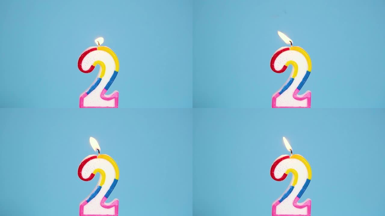 周年视频横幅，蓝色背景上燃烧着五颜六色的二号蜡烛。4k分辨率周年横幅