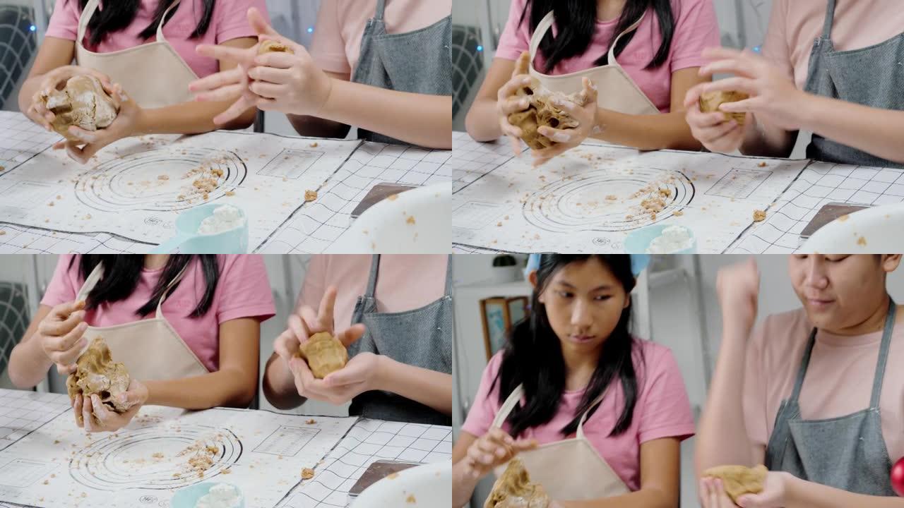 亚洲女孩脱粒糕点面团，然后成型自制饼干来庆祝圣诞节，生活方式概念。