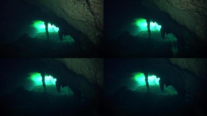 洞穴潜水员朝着cenote开口前进