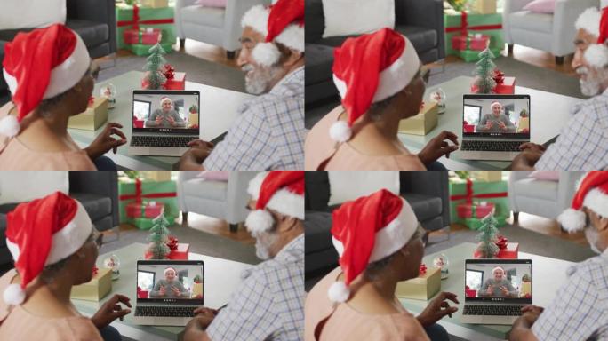 圣诞节时，与资深男性朋友在笔记本电脑上视频通话的快乐非洲裔美国夫妇