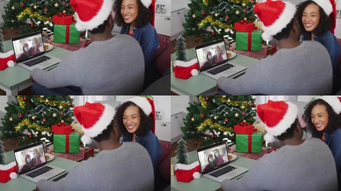 圣诞节时，快乐的非洲裔美国夫妇与戴着口罩的女性朋友进行视频通话