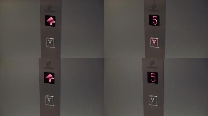 地板上的电梯板。电梯上升。带箭头和红色显示屏的按钮