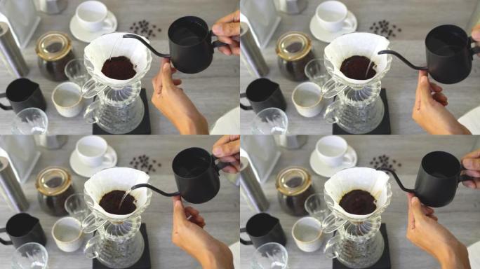 人们煮咖啡，用设备将热咖啡滴入杯子，工具在厨房家中冲泡。顶视图视频4K