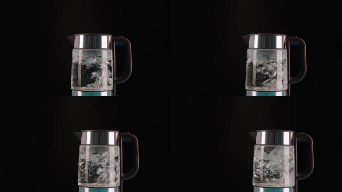 现代玻璃电热水壶，黑色背景，装满水烧开。用来制造饮料和开水。在运动中沸腾。