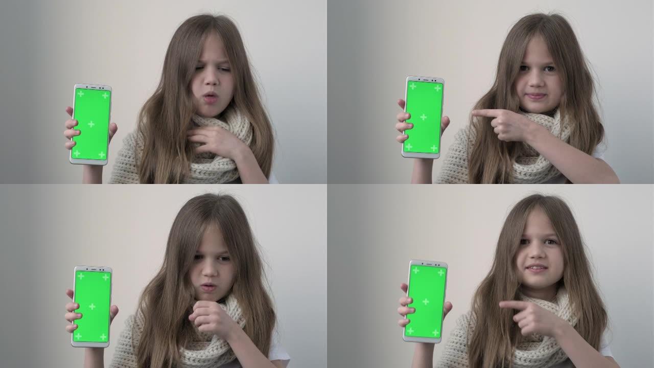 小女孩咳嗽打喷嚏，并显示带有绿屏模型的电话。色度键绿屏智能手机设置用于广告。医生，诊所，药房，药物输