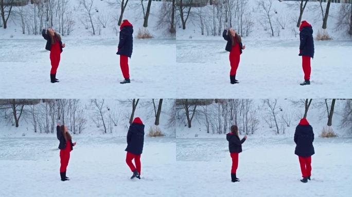 一个年轻快乐的女人在冬天的公园里玩得开心，扔雪，手里很冷，排放的东西不达标。