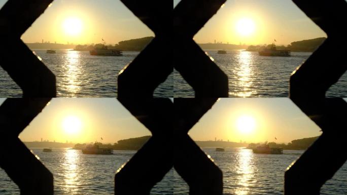 日出时在海上慢动作的渡船。(出现在桥栏杆之间)