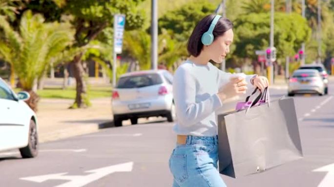 4k视频片段: 一个美丽的年轻女子戴着耳机，在城市购物时喝咖啡