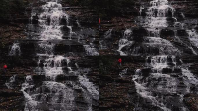 女人从瀑布的侧面爬升时，瀑布的全景图