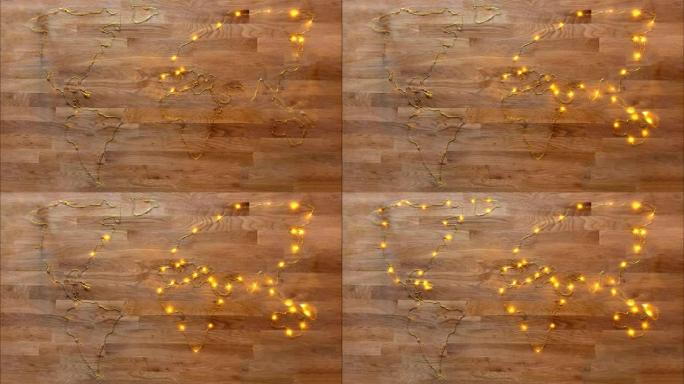 用金色金属丝灯制作的世界地图动画，在质朴的木质背景上逐渐点亮。可用于诸如电力，圣诞节，夜晚，聚会，.