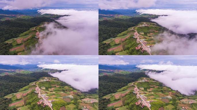 通过带有雾的局部山脉的道路的空中延时视图