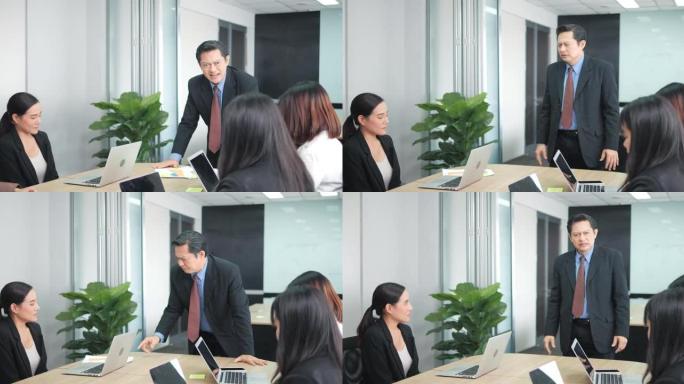 愤怒的亚洲老板在会议室与他的团队开会时对同事大喊大叫。