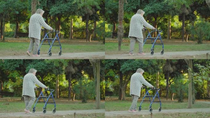 灰发女子带着轮椅沿着公园路行走