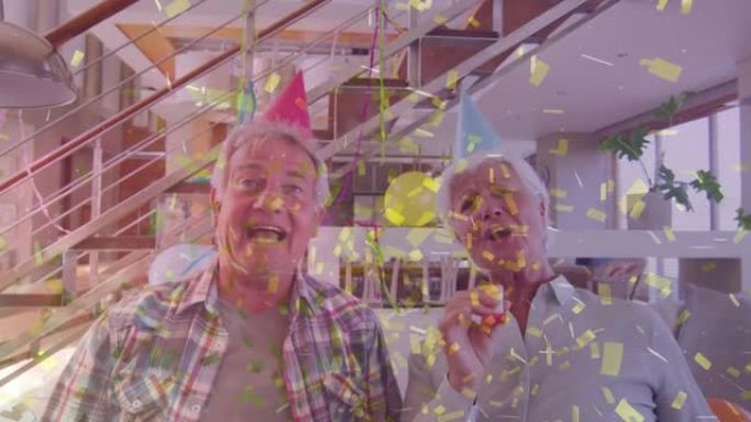 快乐的高加索高级夫妇戴着派对帽做生日视频通话，用金色五彩纸屑