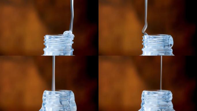 厚厚的透明液体缓慢倒入细流中。塑料瓶颈。糖浆