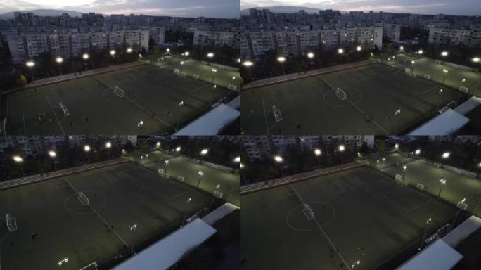 业余足球运动员晚上在城市公园球场比赛